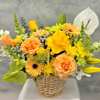 Golden Elegance flower basket featuring peach roses, white anthuriums and seasonal flowers in a woven basket