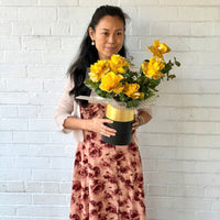 Mellow Yellow 6 yellow glitter roses in a black and gold hatbox