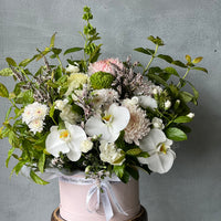 beautiful-hatbox-flower-arrangement-with-orchids-disbuds-chrysanthemums-sesonal-foliage-for-sympathy-funeral
